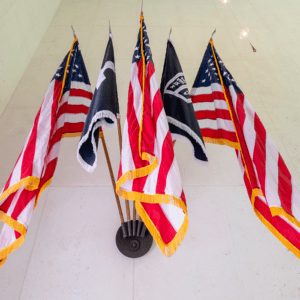 Five American flags displayed on poles.