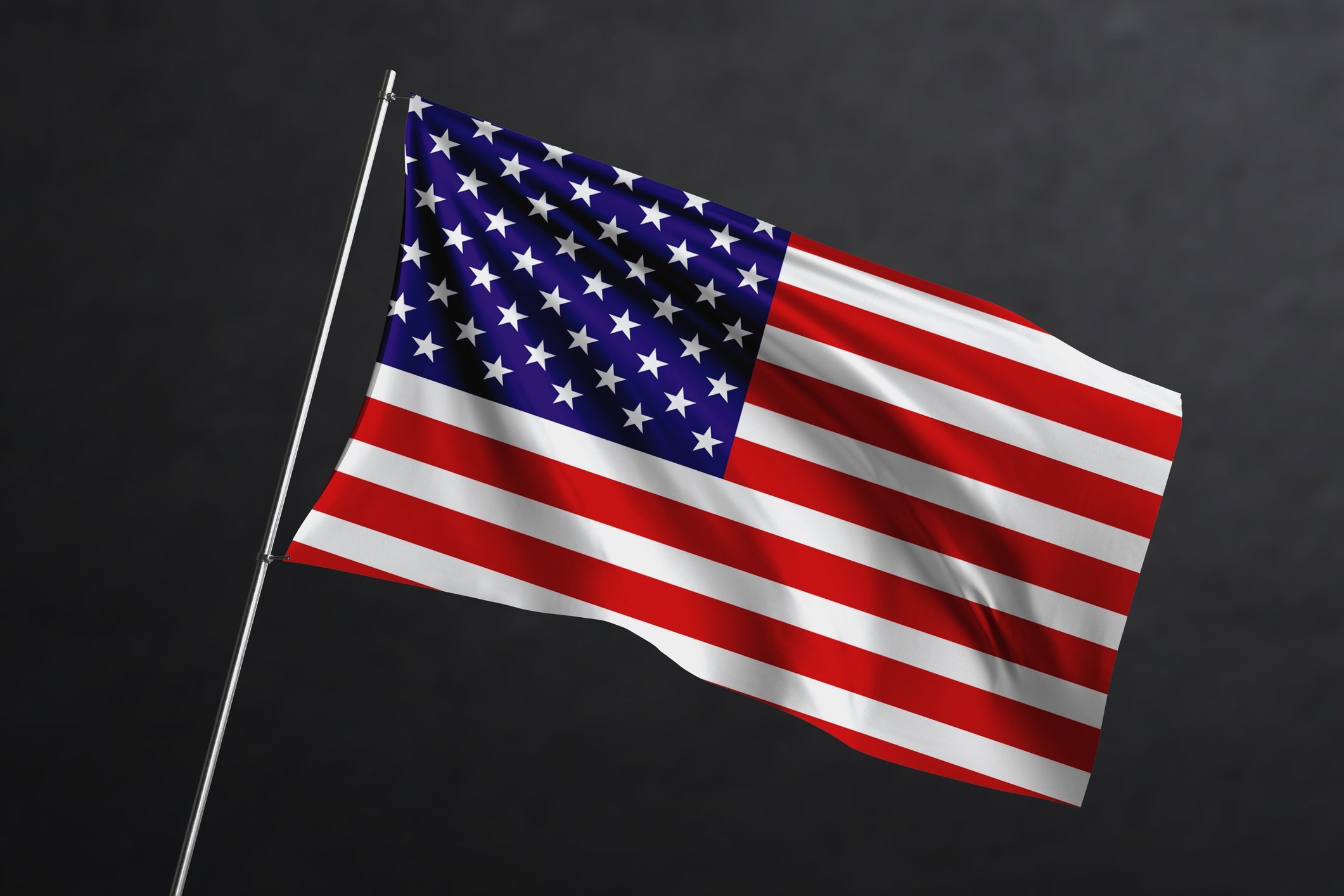 American flag waving against a dark background.
