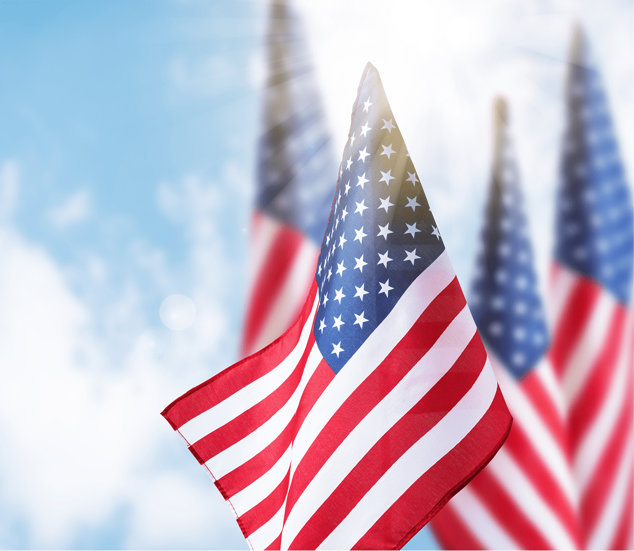 American flags waving against a bright sky.